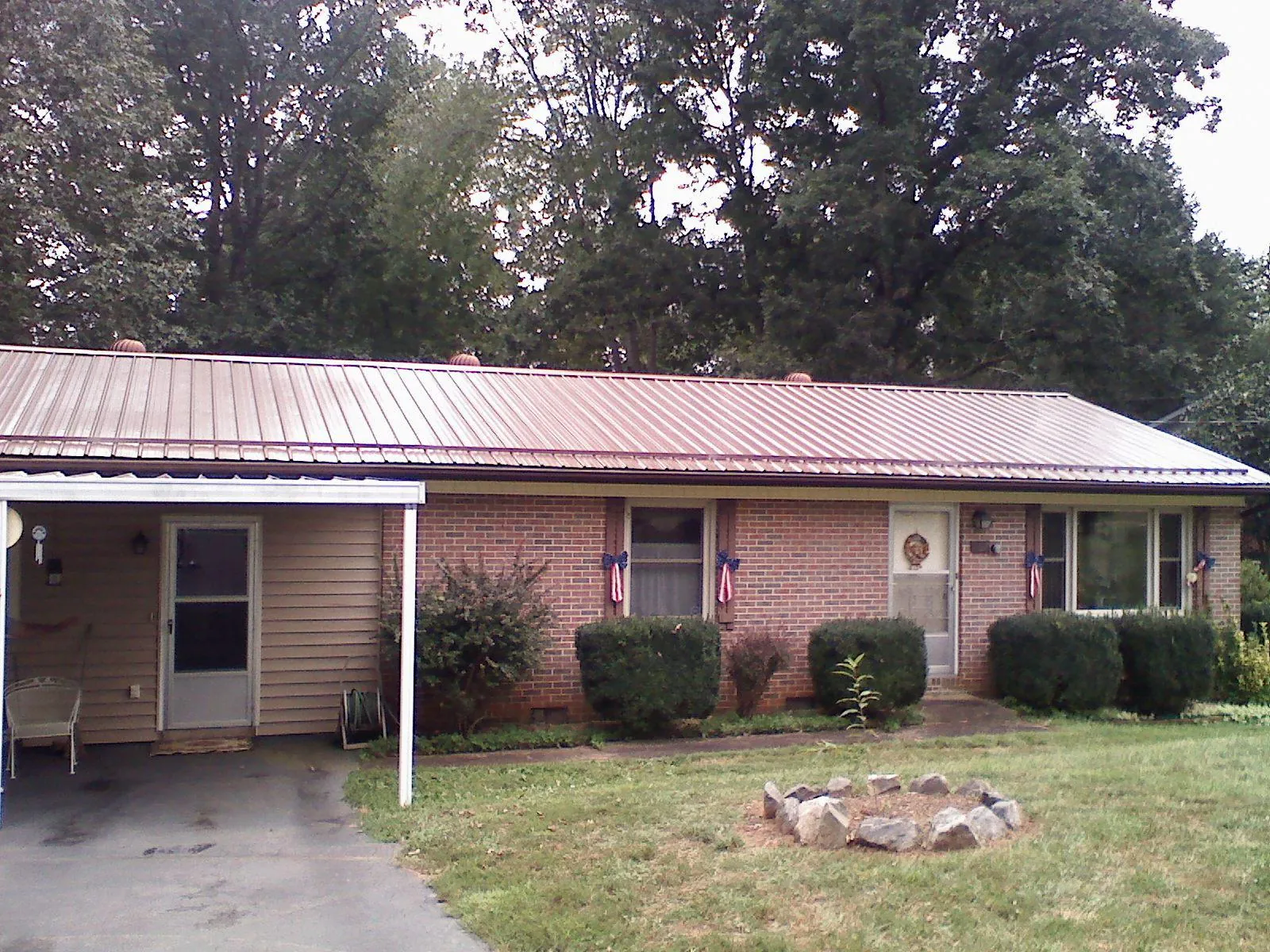 Bronze metal roof and carport on a brick ranch home — Roof Repair work by our crew in Pleasant Mount
