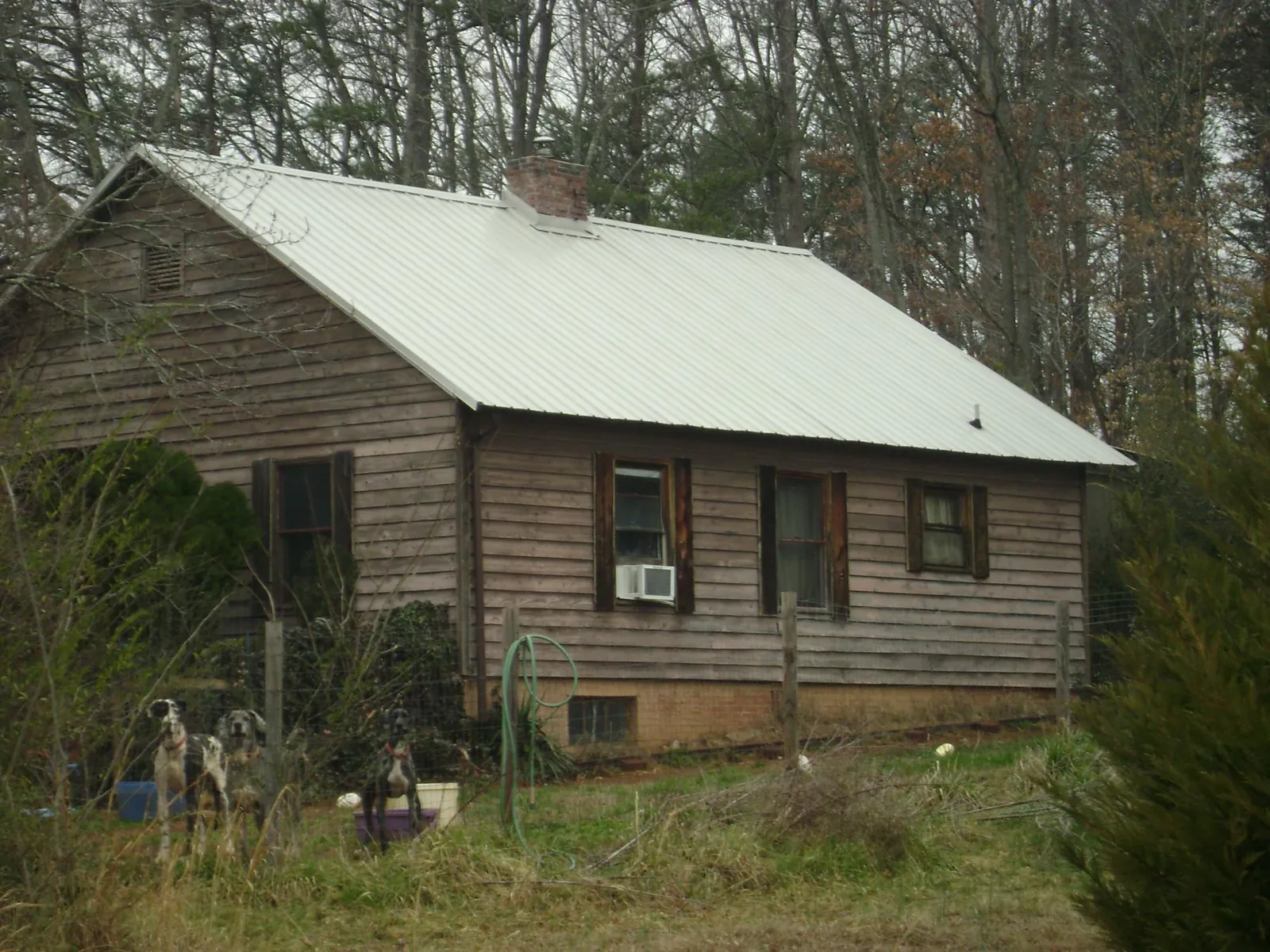 White metal roof on an old wood sided farmhouse, from a Metal Roof Installation job in Pleasant Mount